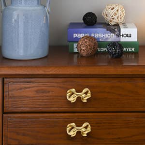 Two knobs installed on drawers of a nightstand