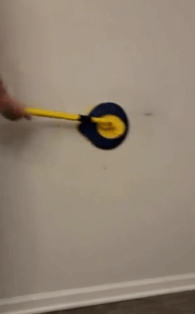 gif of reviewer using the wall mop to remove a dark scuff mark from a wall