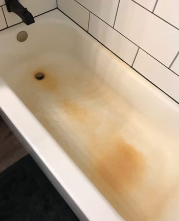 reviewer's bathtub with an orange rust stain