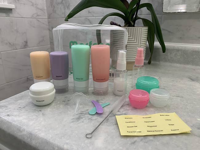 reviewer's  set of travel-sized containers, bottles, and accessories