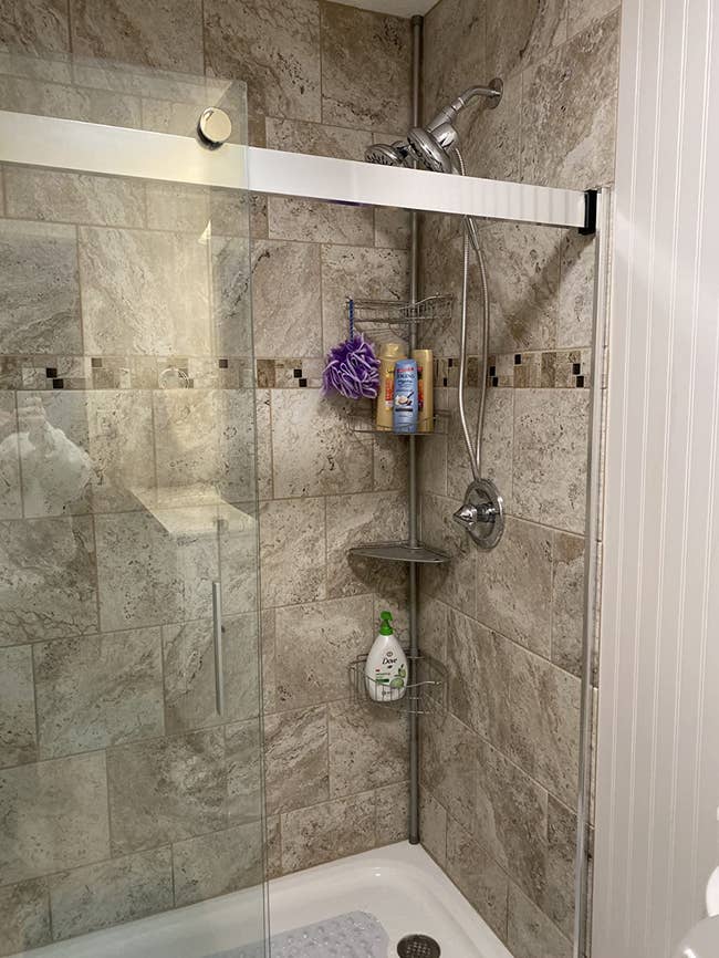 The shower caddy set up in a walk-in shower