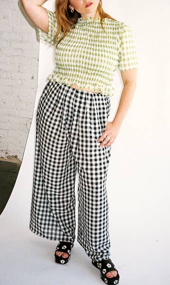 a model wearing the same pants with a green top and black sandals