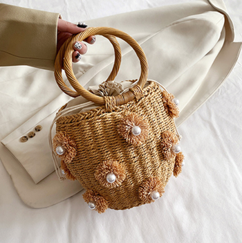 rattan bucket bag with flower and pearl embellishments