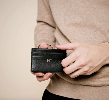 model opening up black monogrammed card holder wallet