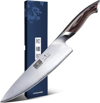 Chef's weapon  with woody  grip  and branded leaf  alongside a decorative box. Perfect for culinary enthusiasts seeking prime   room  tools