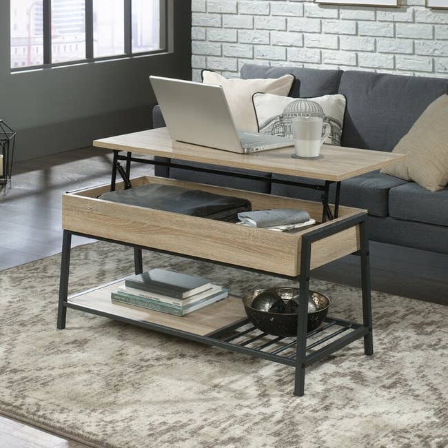 The coffee table, open, in the color Charter Oak