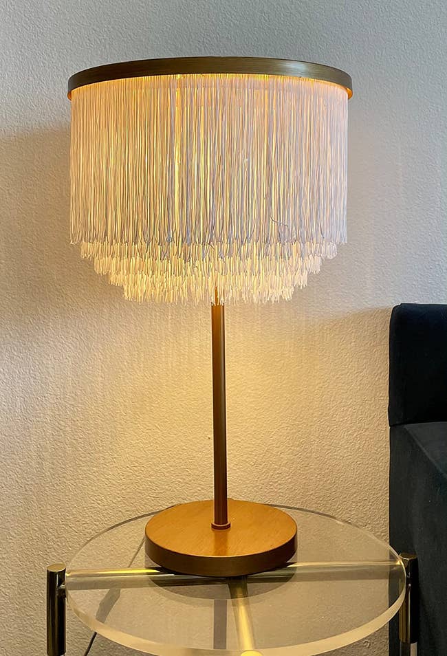 reviewer image of the fringed lamp on a small accent table