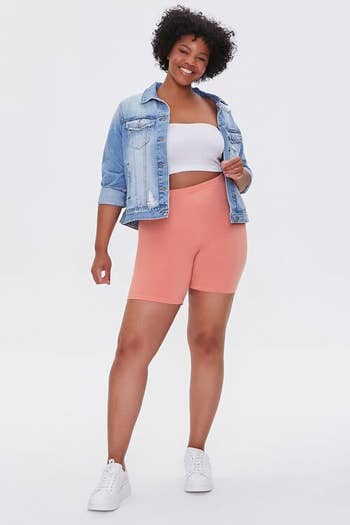 a model wearing the shorts in pink