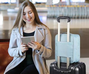 Model next to shoe bag placed on carry-on handle.