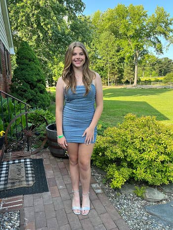 Person poses outdoors successful  a fitted, sleeveless textured formal  and achromatic  heels, suitable for a casual yet stylish outing oregon  event