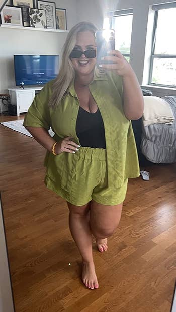 reviewer wearing the short-sleeved blouse and drawstring shorts set in avocado green