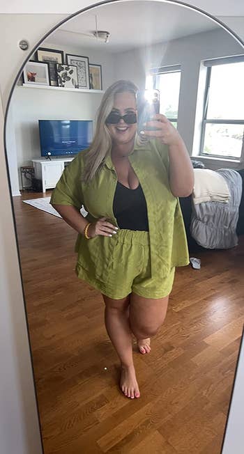 reviewer wearing the short-sleeved blouse and drawstring shorts set in avocado green