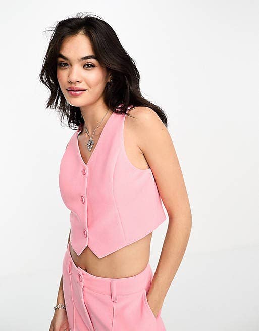 model in pink sleeveless button-front vest