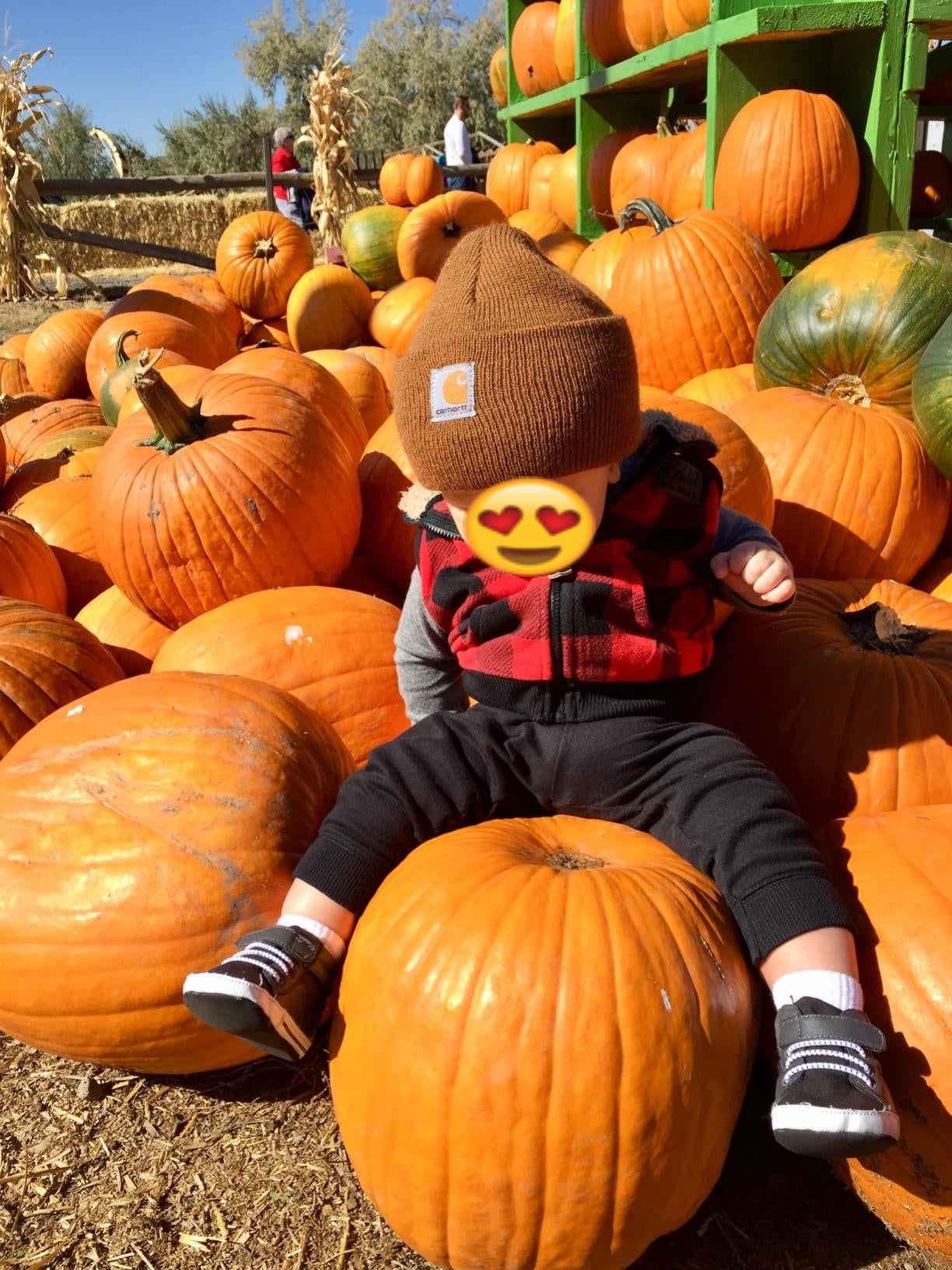 Reviewer's child in a brown beanie at the pumpkin patch