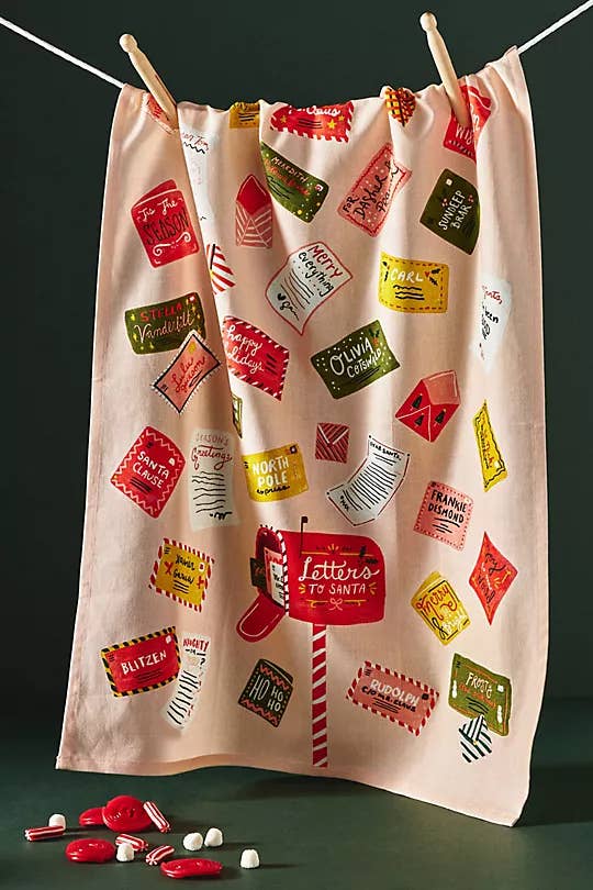 a dish towel with letters to santa scattered on it