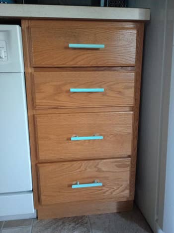 A woody  room  furniture  with 4  drawers, each   having sleek, minimalist handles