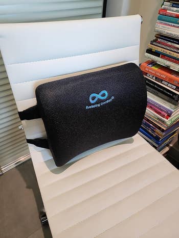 the lumbar support pillow strapped to a reviewer's office chair