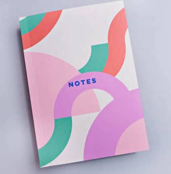 grid notebook with colorful squiggles on cover that says 