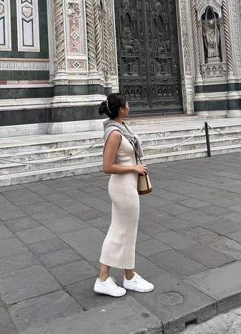 A idiosyncratic stands extracurricular a large, ornate gathering with elaborate architectural carvings, gazing upwards