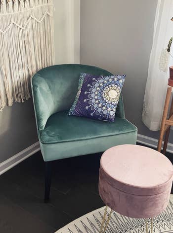 reviewer's pink ottoman in front of a teal accent chair