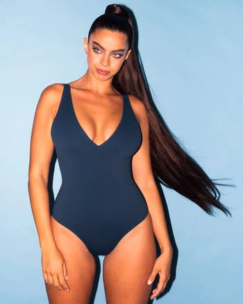 model wearing the plunging v-neck one piece in blue