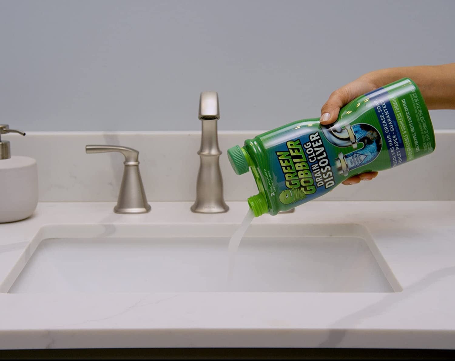 model pouring the dissolver into a sink