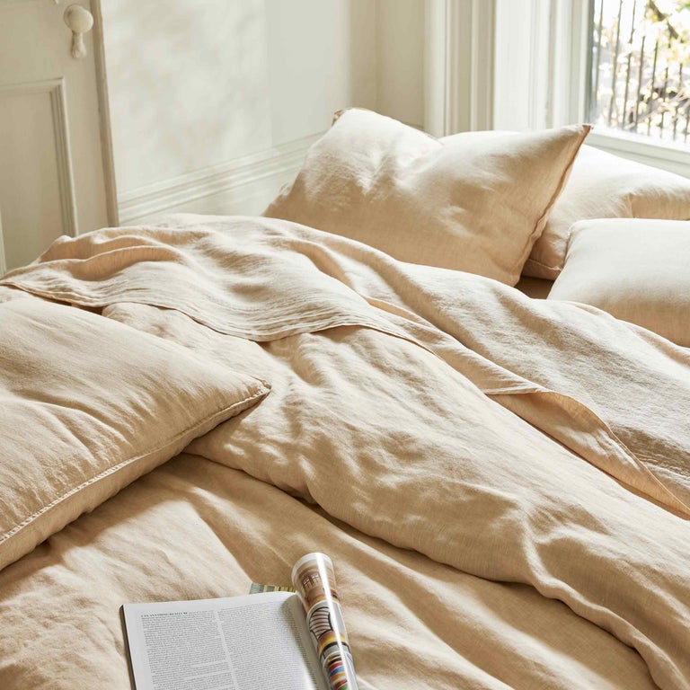 the khaki linen sheets set up on a bed