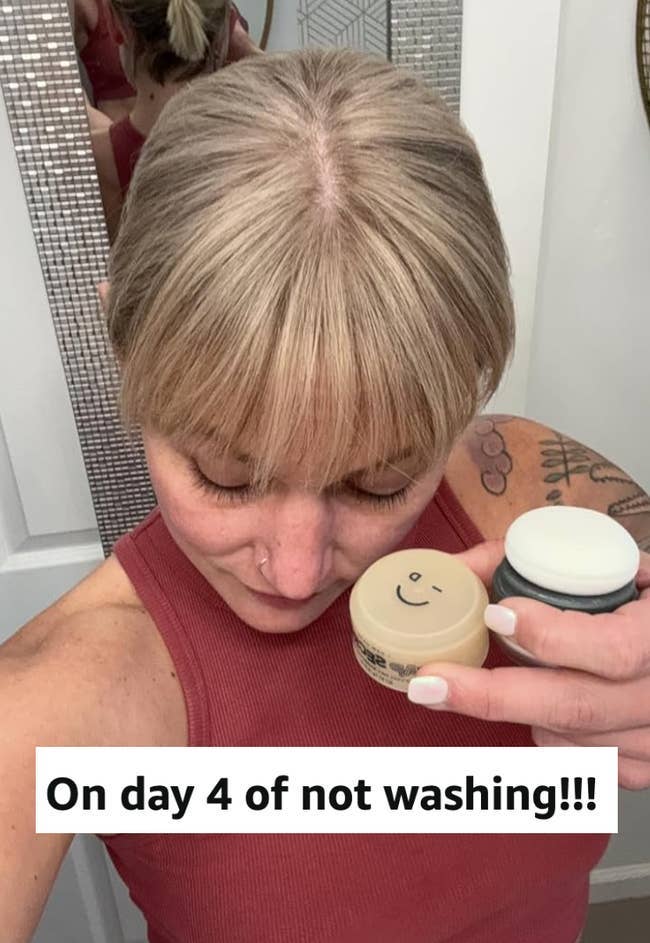 Person showing hair texture while holding hair product containers; caption: 