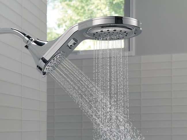 water coming out of both of the the stainless-steel showerhead's heads