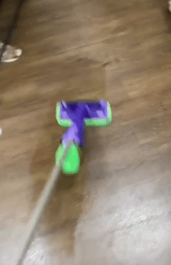 A mop cleaning a hardwood floor, demonstrating effectual  cleaning enactment   successful  a buying  context