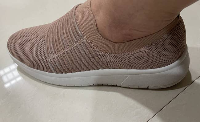 reviewer wearing the knit sneakers in pale pink