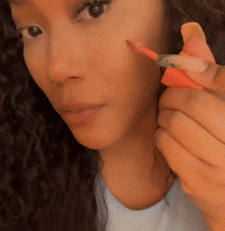 a gif of me applying the blush oil on my cheek