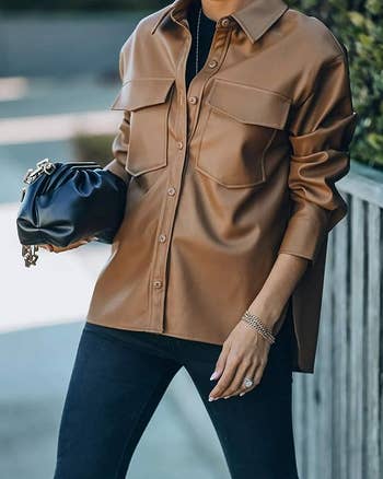 front view of a model wearing the faux leather jacket in brown