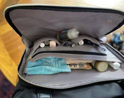 reviewer photo showing small items packed into the tote's interior pockets