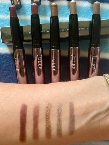 Arm displaying swatches of Julep eyeshadow sticks