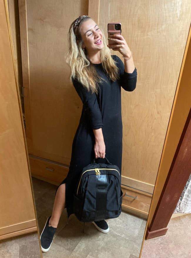 Reviewer in black maxi crewneck dress with long sleeves 