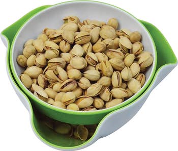 The same bowl with pistachios and the shells in the bottom compartment 