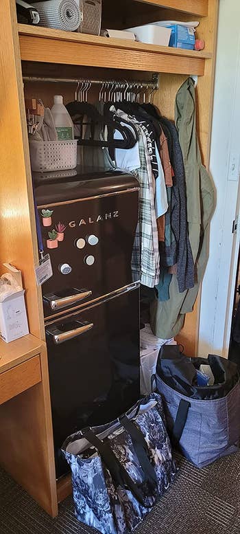 the black fridge in a reviewer's closet in their dorm room