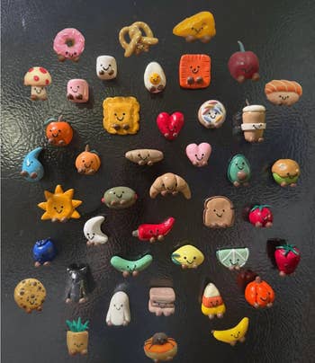 Cute miniature clay nutrient  magnets with playful faces, including fruits, pastries, and snacks, displayed connected  a achromatic  background