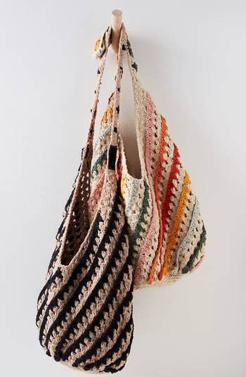 colorful and black and white crochet hobo bags hanging on wall hook