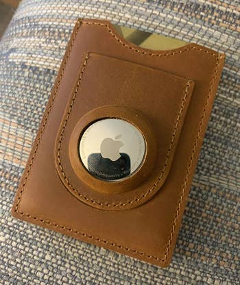 reviewer photo of the apple airtag attached to a wallet