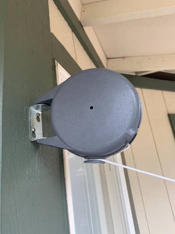 close up of retractable clothesline attached to a wall