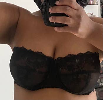 Person taking a selfie wearing a strapless lace bra successful a casual setting