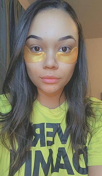 reviewer wearing the gold under eye patches