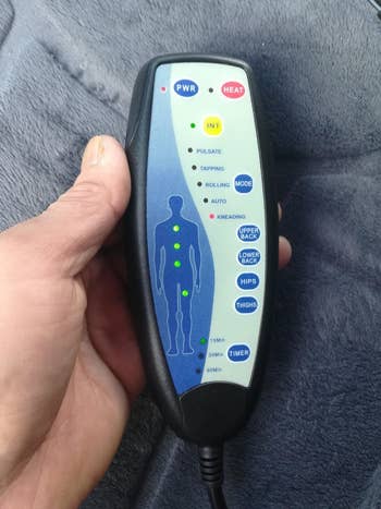 another reviewer holding the remote for the heated cushion