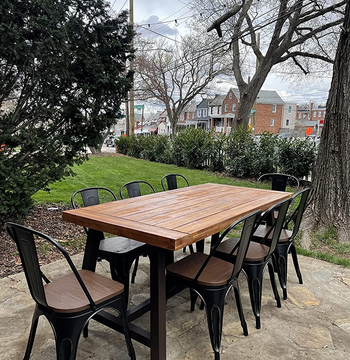 another reviewer's outdoor table during the day with eight brown/black chairs around it