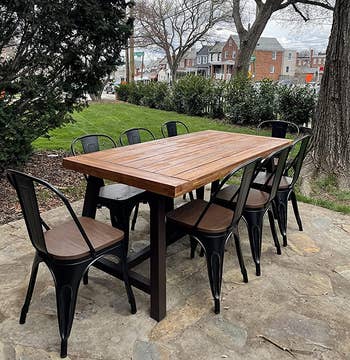 another reviewer's outdoor table during the day with eight brown/black chairs around it