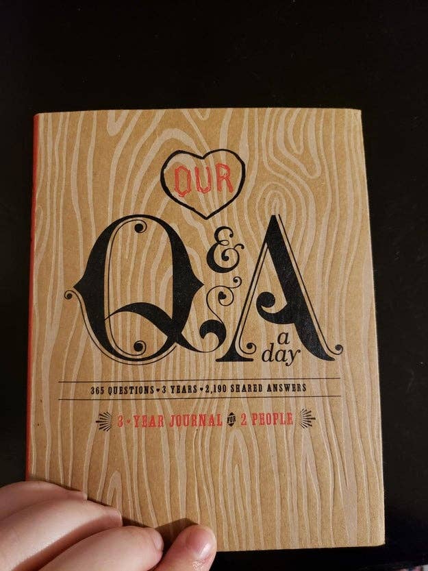 a reviewer showing the cover of the Q&A book