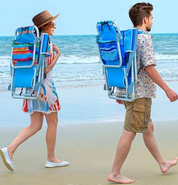 Two radical carrying formation chairs with backpack straps walking on a beach. The chairs diagnostic colorful cloth patterns