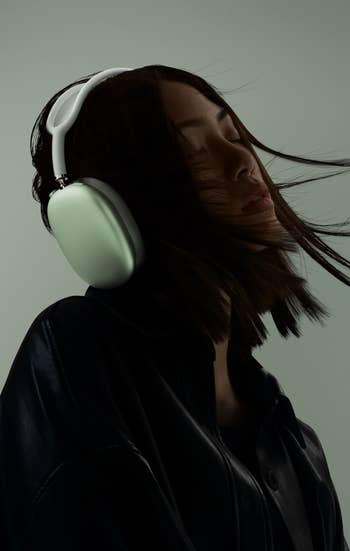 a model wearing the headphones in green